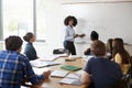 Female High School Tutor At Whiteboard Teaching Maths Class Royalty Free Stock Photo