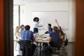 Female High School Tutor At Whiteboard Teaching Maths Class With Pupil Asking Question Royalty Free Stock Photo