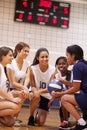 Female High School Volleyball Team Have Team Talk From Coach Royalty Free Stock Photo