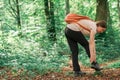 Female hiker with ankle injury in forest