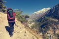 Female hiker ascending a slope.