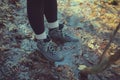 Female hiker with boots in leafy puddle