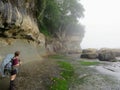 A female hiker carefull navigating the coast line along the West Coast Trail Hike Royalty Free Stock Photo