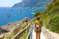 Female hiker descent the pathway with spectacular landscape of Capri, Naples, Italy