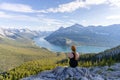 Female hiker enjoying vista on beautiful alpine valley and lake in Canadian Rockies, Rimwall Summit, Canada