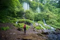 Female hiker enjoys Benang Kelambu waterfall view