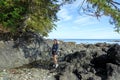 A female hiker exploring the sandy beaches of nels bight and experimental bight, surrounded by forest and the pacific ocean
