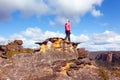 Female hiker high on a mountain pagoda looking at view