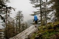 Female hiker hikes up to top of the mountain