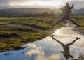 Female Hiker Jumps Stream in Arran Scotland Royalty Free Stock Photo