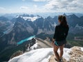 Female hiker looking on Moraine Lake from summit of Mount Temple, Banff, Canadian Rockies, Canada Royalty Free Stock Photo