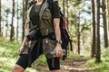 Female hiker with modern mirrorless camera in green forest