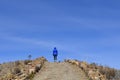 A female hiker on a mountain path, trail, sunny day, Titicaca Lake Royalty Free Stock Photo