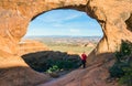 Female hiker at Partition Arch in Arches National Park