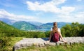 Female hiker relaxing after trekking on mountains enjoying view from belvedere Royalty Free Stock Photo