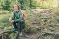 Female hiker resting and contemplating in forest
