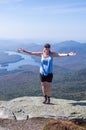 Female hiker with her arms out at the summit of Whiteface Mountain Royalty Free Stock Photo