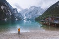 Female hiker standing next to the beautiful mountain lake Royalty Free Stock Photo