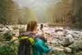 Female hiker taking photo of Himalayan river Modi Khola