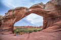 Female Hiker under Broken Arch, Arches National Park Moab Utah