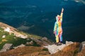 Female hiker in unicorn costume celebrating success in mountains Royalty Free Stock Photo