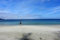 A female hiker walking along the ocean of the sandy beaches of nels bight and experimental bight, beside forest and the pacific Royalty Free Stock Photo