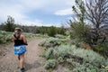 Female hiker walks on a dirt hiking trail in Miners Delight Wyoming to explore a ghost town Royalty Free Stock Photo