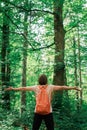 Female hiker with wide spread hands in forest Royalty Free Stock Photo