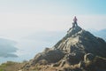 Female hikers on top of the mountain taking a break and enjoying a valley view Royalty Free Stock Photo