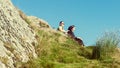 Female hikers on top of the mountain taking a break and enjoying a valley view Royalty Free Stock Photo