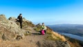 Female hikers on top of the mountain taking a break and enjoying a valley view Royalty Free Stock Photo