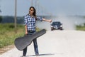 A Female Hitchhikes On A Dirt Road Royalty Free Stock Photo