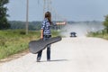 A Female Hitchhikes On A Dirt Road Royalty Free Stock Photo