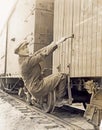 Female hobo climbing freight train Royalty Free Stock Photo