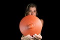 Of a female holding a clay pot lid on black background Royalty Free Stock Photo