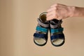 Female is holding close-up a special children`s orthopedic shoe sandals made of genuine leather.