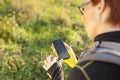 Female holding digital compass in the nature