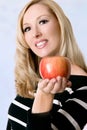 Female holding a fresh red apple Royalty Free Stock Photo