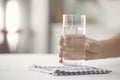 Female holding glass of water on kicthen table Royalty Free Stock Photo