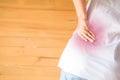 Female holding hand to spot of Abdomen. Concept photo with red spot indicating location of the pain Royalty Free Stock Photo