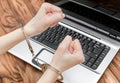 Female holding hands in handcuffs over laptop. Online crime concept Royalty Free Stock Photo