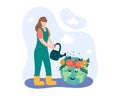 Female holding watering can and watering planet. Global warming concept