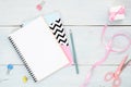 Female home office desk. Beauty blogger workspace with blank paper notepad, pen, small gift box, ribbon and feminine accessories Royalty Free Stock Photo