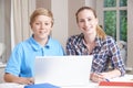 Female Home Tutor Helping Boy With Studies Using Laptop Royalty Free Stock Photo