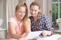 Female Home Tutor Helping Girl With Studies Using Digital Tablet