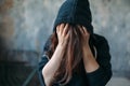 Female in a hoodie holds her head Royalty Free Stock Photo