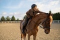 Female horse trainer with her stallion outdoors in farm