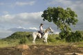 Female horseback rider and horse ride overlooking Lewa Wildlife Conservancy in North Kenya, Africa