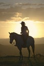 Female horseback rider and horse ride to overlook at Lewa Wildlife Conservancy in North Kenya, Africa at sunset Royalty Free Stock Photo