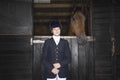 Female Horseback Rider With Horse In Stable Royalty Free Stock Photo